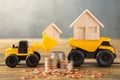 Model house in loader, Dump truck, coins stack on wooden desks and loft walls with sunlight and copy space for money saving