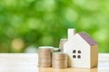 a model house model is placed on a pile of coins.using as background business concept and real estate concept with copy space for Royalty Free Stock Photo