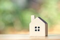 A model house model is placed on a pile of coins.using as background business concept and real estate concept with copy space for Royalty Free Stock Photo