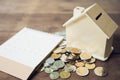 A model house model is placed on a pile of coins.using as background business concept and real estate concept with copy space for Royalty Free Stock Photo