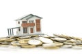 A model house model is placed on a pile of coins.using as background business concept and real estate concept Royalty Free Stock Photo