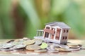 A model house model is placed on a pile of coins. using as background business concept and real estate concept with copy space Royalty Free Stock Photo