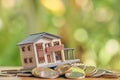 A model house model is placed on a pile of coins.using as background business concept and real estate concept with copy space Royalty Free Stock Photo