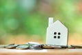 A model house model is placed on a pile of coins.using as background business concept and real estate concept with copy space for Royalty Free Stock Photo