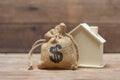 A model house model is placed on a pile of coins.using as background business concept and real estate concept with copy space for Royalty Free Stock Photo