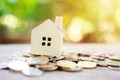 A model house model is placed on a pile of coins.using as background business concept and real estate concept with copy space for Royalty Free Stock Photo