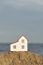 Model house on sea background. Purchase of real estate by sea. Construction of cottage on shore