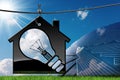 Model House with Solar Panel and Light Bulb Royalty Free Stock Photo