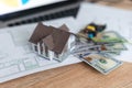 Model house on top of money pile suggesting savings for a house Royalty Free Stock Photo