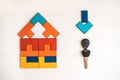 Model house from wooden puzzle with key. Royalty Free Stock Photo