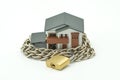 Model house wrapped with steel chain and padlock. Ideas Security Royalty Free Stock Photo