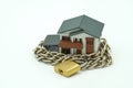 Model house wrapped with steel chain and padlock. Ideas Security Royalty Free Stock Photo