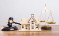 Model houses and judge hammers on tables, real estate disputes, real estate auctions
