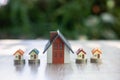 Model houses and houses on a pile of coins Planning ideas for real estate investing, saving and buying homes, mortgages Royalty Free Stock Photo