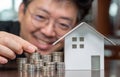 Model houses and stacked coins. Home equity loans. Mortgages and loans