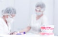 The model of the jaw stands on the table against the background of doctors who are treating teeth Royalty Free Stock Photo