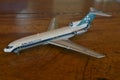 DieCast, commercial aircraft of Brazilian company in scale, top-down view, vintage wood background,