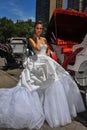 Model Kalyn Hemphill poses in front of horse carriage