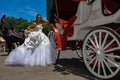 Model Kalyn Hemphill poses in front of horse carriage at the Irina Shabayeva SS 2016 Bridal photo shoot