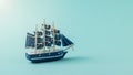 A model of a large sailboat on a blue background in the sun Royalty Free Stock Photo