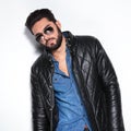 Model in leather jacket and sunglasses posing Royalty Free Stock Photo