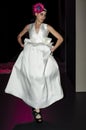 Model lifting her bridal gown backstage