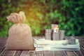 Model little house placed on stacking coins and banknote with money bag sack.