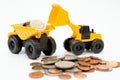 Model loader, Dump truck, coins stack on white background for money saving concept