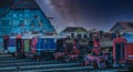 Model locomotives in a train station in the night scene