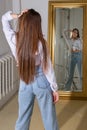 Model with long hair looking and reflecting in the mirror Royalty Free Stock Photo