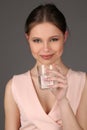 Model with makeup drinking water. Close up. Gray background Royalty Free Stock Photo