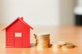 Model of miniature houses made of wood and gold coins. Generative AI Royalty Free Stock Photo