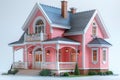 Model of miniature two-story pink house with gray roof in the form of plastic toy figure, with flower beds near the