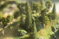 Model of mountainous area. Miniature trees in toy park. Mountain landscape made of plastic