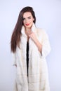 Model in natural fur coat looking at camera Royalty Free Stock Photo