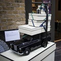 A model of an old car with gifts tied to the roof and wrapped in boxes adorns the entrance to a store in Spitalfields Market