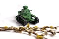 Model of an old Soviet tank made of paper on a white background. Willow branch in the foreground Royalty Free Stock Photo