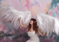 Model with open angel wings with pink sky background Royalty Free Stock Photo
