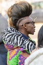 Model with an original hairstyle wearing a zebra jacket