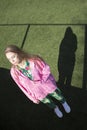 Model in a pink sweater on a green background. Royalty Free Stock Photo