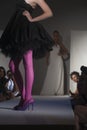 Model In Pink Tights And Black Dress On Fashion Catwalk