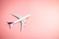 Model plane, top view of airplane on pink color background. travel planning concept