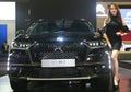 Model posed with DS7 Crossback SUV from the French automaker DS Automobiles, displayed