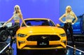 Model posed with yellow Ford Mustang BULLITT 5.0 displayed during Kuala Lumpur