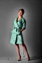 Model posing in light green raincoat standing in the studio. Retro style Royalty Free Stock Photo