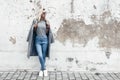 Model posing in plain tshirt against street wall