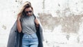 Model posing in plain tshirt against street wall