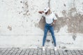 Model posing in plain tshirt against street wall