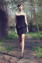 Model posing in short black dress