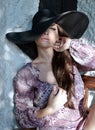 Model posing in wide brimmed hat